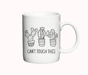 Hvidt kaffekrus med tegninger af tre forskellige kaktusser i potter og teksten "Can't Touch This" i sort skrift.