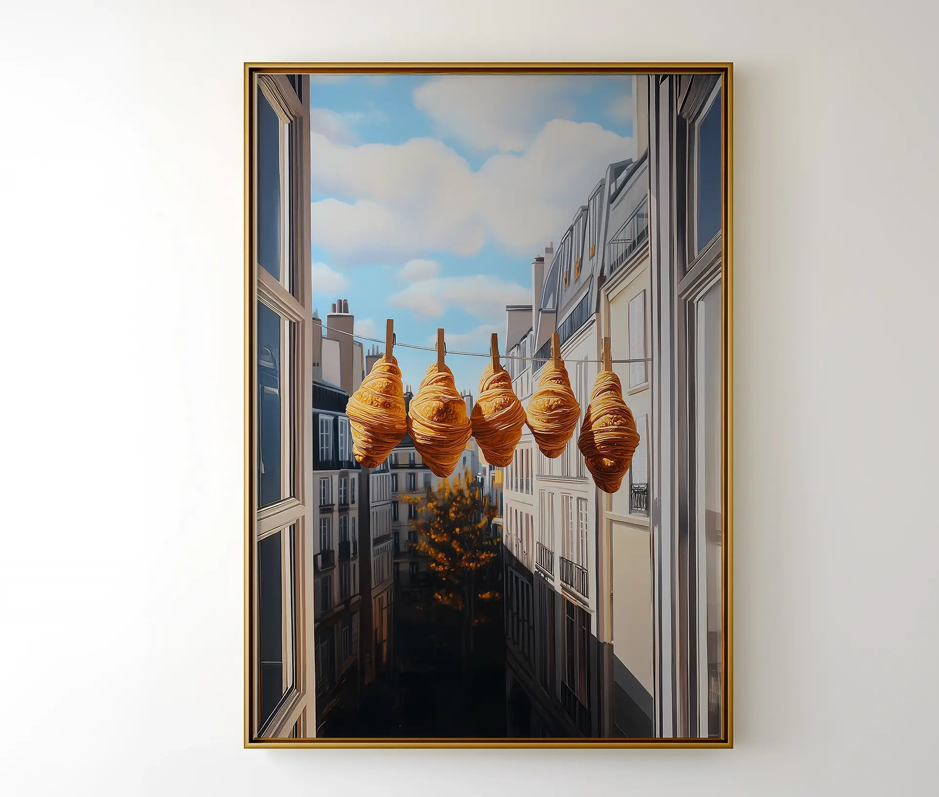 Plakat med croissanter i snor monteret i ramme og hængt op på væg.