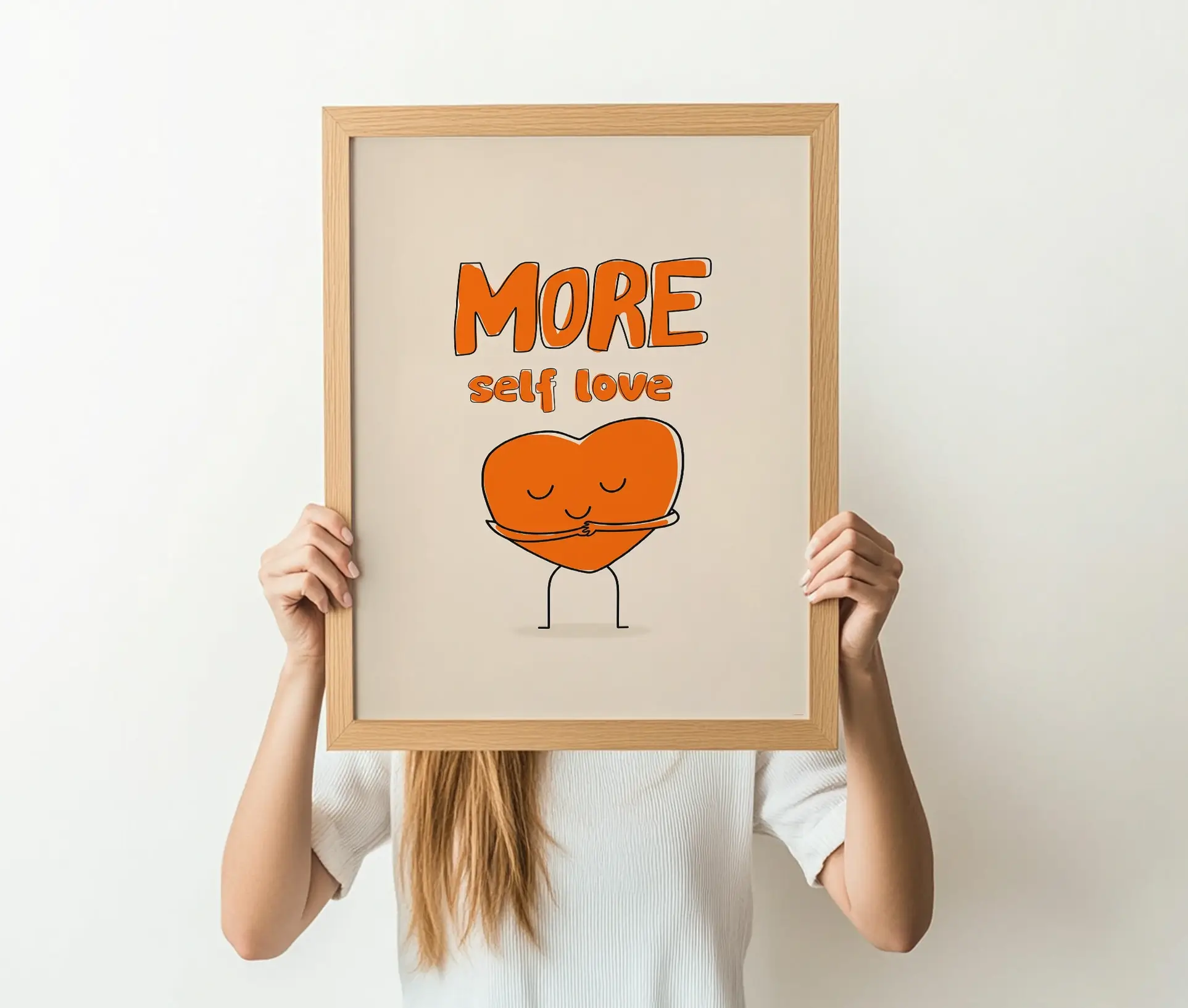 Person holder plakat med orange hjerte og teksten "More self love" foran ansigtet