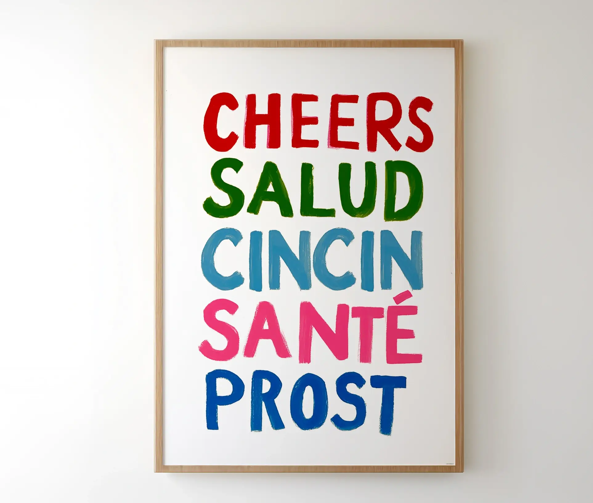 Indrammet plakat med ord som "CHEERS" og "SALUD" i farverig typografi.